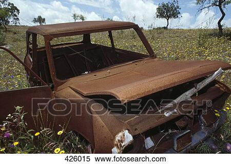 Stock Photography - Abandoned car in a meadow. Fotosearch