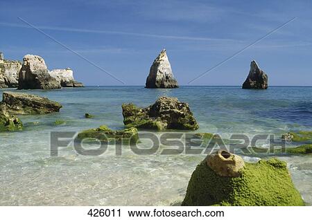 Stock Image - Rock formations along the coastline, Lagos, Algarve, Portugal. Fotosearch