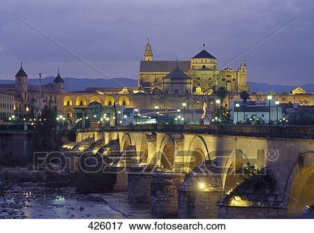 Stock Photo - View of the La Mezquita Mosque and Cathedral over a bridge, Cordoba, Spain. Fotosearch