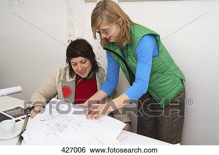 Architects looking at drawings View Large Photo Image Stock Photograph - Architects looking at drawings. Fotosearch