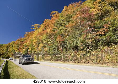 Car driving along road View Large Photo Image Stock Photograph - Car driving along road. Fotosearch