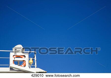 A metal platform with a lifebuoy attached to the railing View Large Photo Image Stock Image - A metal platform with a lifebuoy attached to the railing. Fotosearch