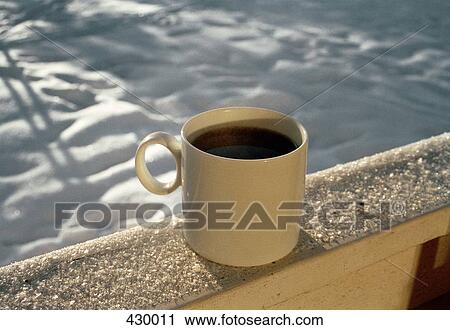 Cup of coffee on balcony railing View Large Photo Image Stock Image - Cup of coffee on balcony railing. Fotosearch