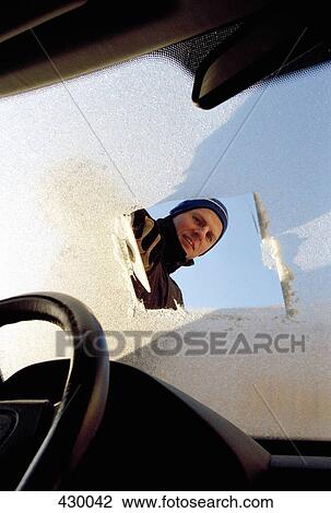 Man looking through frost covered windshield View Large Photo Image Stock Image - Man looking through frost covered windshield. Fotosearch