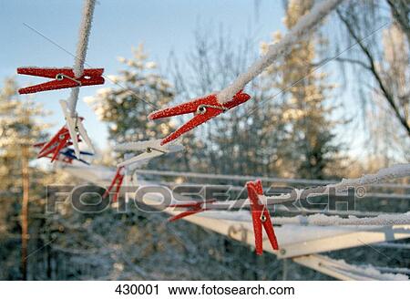 Stock Image - Pegs on a frosty clothes line. Fotosearch