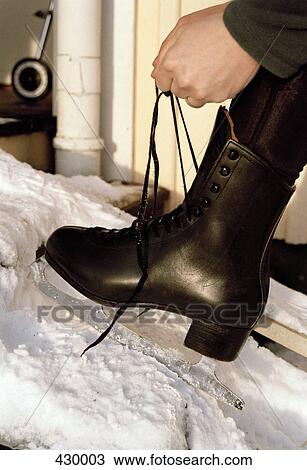 Person tying laces on an ice skate View Large Photo Image Stock Image - Person tying laces on an ice skate. Fotosearch