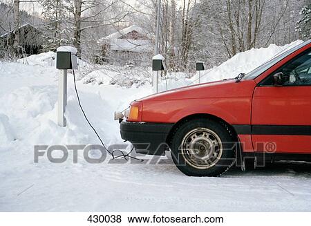 Power cable connected to a parked car in the winter View Large Photo Image Stock Photo - Power cable connected to a parked car in the winter. Fotosearch
