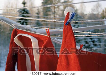 Santa Claus costume hanging on a clothesline View Large Photo Image Stock Photo - Santa Claus costume hanging on a clothesline. Fotosearch