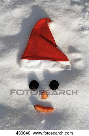 Snowman's face with a Santa hat in the snow View Large Photo Image Stock Image - Snowman's face with a Santa hat in the snow. Fotosearch