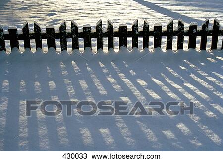 Sun shining on wooden picket fence in the snow View Large Photo Image Stock Image - Sun shining on wooden picket fence in the snow. Fotosearch