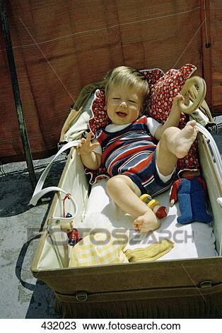 Stock Image - Baby boy in a pram. Fotosearch