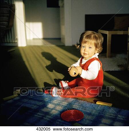 Baby playing on the floor View Large Photo Image Stock Photography - Baby playing on the floor. Fotosearch