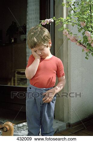 Boy standing in doorway resting his head in his hand View Large Photo Image Stock Photo - Boy standing in doorway resting his head in his hand. Fotosearch