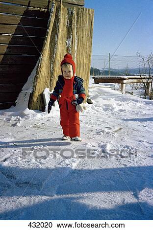 Boy standing in garden in the snow View Large Photo Image Stock Image - Boy standing in garden in the snow. Fotosearch
