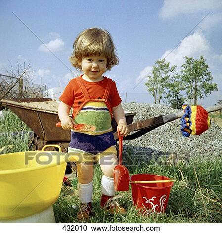 Girl playing in garden View Large Photo Image Stock Image - Girl playing in garden. Fotosearch