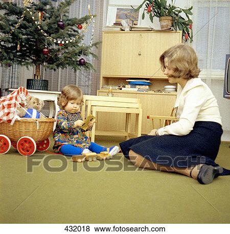 Mother and daughter playing in the living room at Christmas View Large Photo Image Stock Photo - Mother and daughter playing in the living room at Christmas. Fotosearch