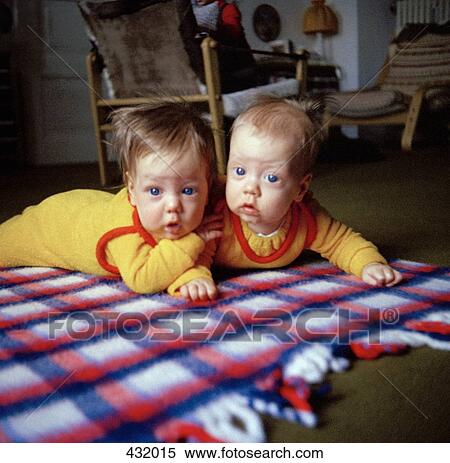 Two babies lying on rug View Large Photo Image Stock Photography - Two babies lying on rug. Fotosearch
