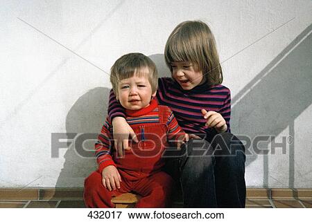 Stock Photo - Two children sitting together. Fotosearch