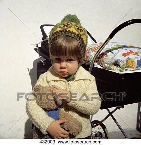 Young girl holding teddy bear View Large Photo Image Stock Image - Young girl holding teddy bear. Fotosearch