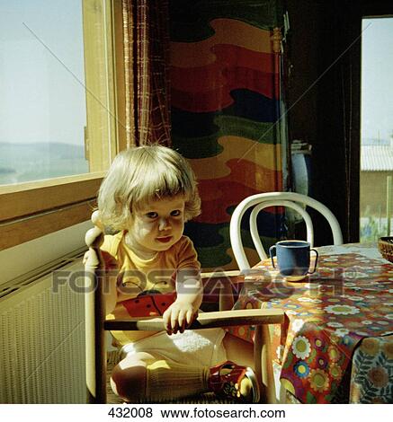 Young girl sitting at a table View Large Photo Image Stock Photo - Young girl sitting at a table. Fotosearch