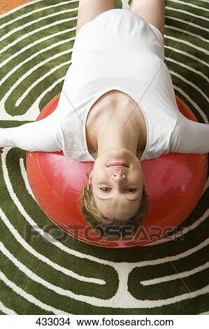 Pregnant woman stretching on a fitness ball View Large Photo Image Picture - Pregnant woman stretching on a fitness ball. Fotosearch