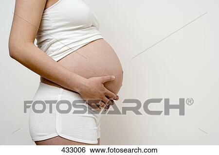 Side view of a pregnant woman View Large Photo Image Stock Photograph - Side view of a pregnant woman. Fotosearch