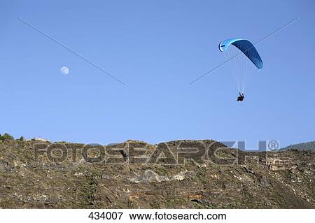 A paraglider in the sky View Large Photo Image Stock Photo - A paraglider in the sky. Fotosearch