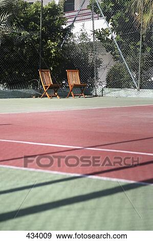 Sun loungers at the edge of a tennis court View Large Photo Image Stock Photo - Sun loungers at the edge of a tennis court. Fotosearch