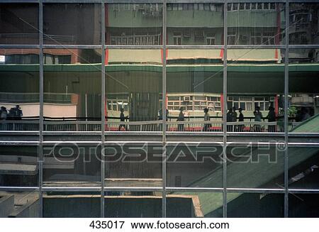 Stock Photo - A building with reflections of city life on the facade, Hong Kong, China. Fotosearch