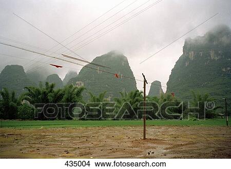 Picture - Electricity pylons and power lines in front of rock formations, Yangshou, China. Fotosearch