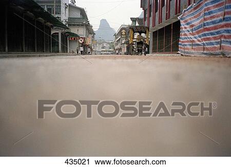 Street scene with rock formation in the distance, Yangshou, China View Large Photo Image Stock Image - Street scene with rock formation in the distance, Yangshou, China. Fotosearch