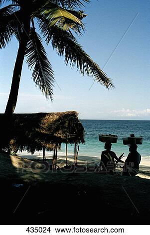 Two people walking along a beach and balancing baskets on their heads, Padang Bai, Bali, Indonesia View Large Photo Image Picture - Two people walking along a beach and balancing baskets on their heads, Padang Bai, Bali, Indonesia. Fotosearch