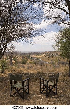 Stock Image - Two empty chairs overlooking African landscape. Fotosearch