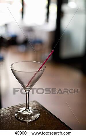 Stock Image - Empty martini glass on a bar. Fotosearch
