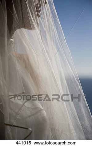 A bride wearing a veil and looking out to sea View Large Photo Image Stock Photography - A bride wearing a veil and looking out to sea. Fotosearch