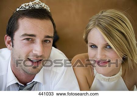 A groom wearing a tiara whilst lying down beside a bride View Large Photo Image Stock Image - A groom wearing a tiara whilst lying down beside a bride. Fotosearch