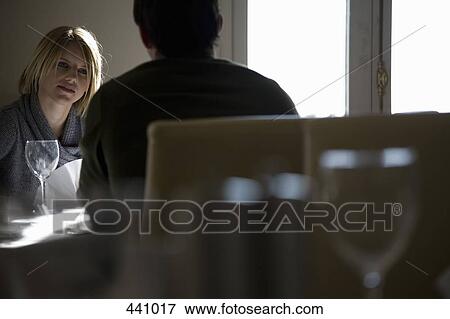 A man and a woman sitting at a table in a restaurant View Large Photo Image Stock Photo - A man and a woman sitting at a table in a restaurant. Fotosearch