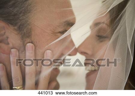 Close-up of a bride and a groom embracing View Large Photo Image Stock Image - Close-up of a bride and a groom embracing. Fotosearch