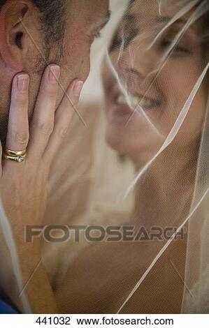 Close-up of a bride and a groom embracing View Large Photo Image Stock Image - Close-up of a bride and a groom embracing. Fotosearch