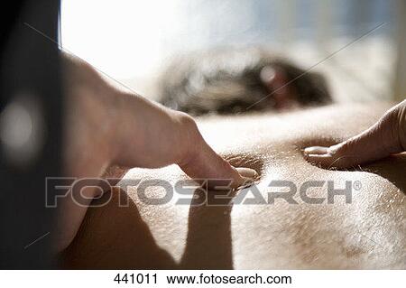 Close-up of a woman massaging a man's back View Large Photo Image Stock Image - Close-up of a woman massaging a man's back. Fotosearch