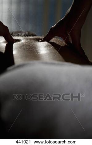 Stock Image - Close-up of a woman massaging a man's back. Fotosearch