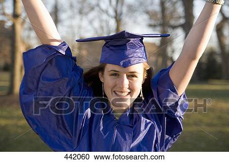 Stock Image - Female student celebrating graduation. Fotosearch