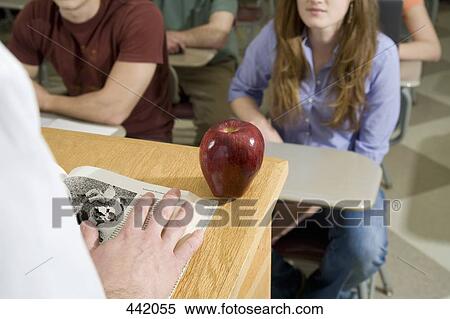 Lecturer standing at lectern with an apple View Large Photo Image Stock Photography - Lecturer standing at lectern with an apple. Fotosearch