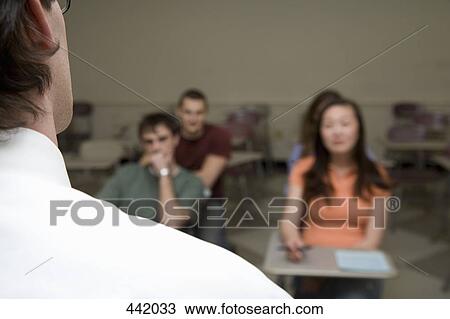 Stock Image - Lecturer standing in front of students. Fotosearch