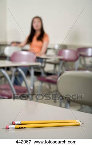 Stock Photo - Pencils on a desk in a lecture room. Fotosearch