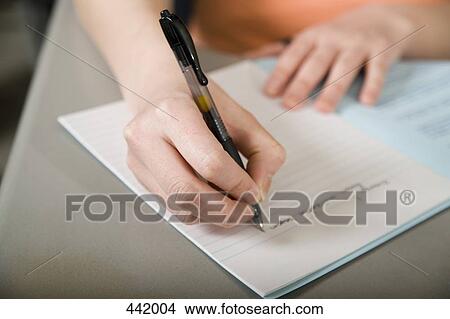 Picture - Person writing in notebook. Fotosearch