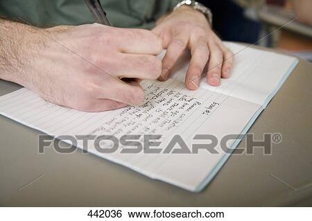 Stock Photograph - Person writing in notebook. Fotosearch