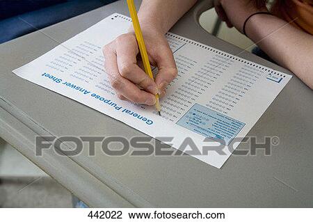 Stock Image - Student taking an exam. Fotosearch