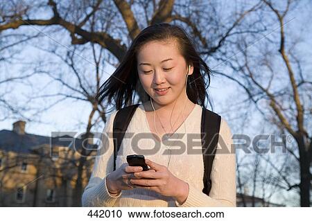 Student using mobile phone View Large Photo Image Stock Image - Student using mobile phone. Fotosearch