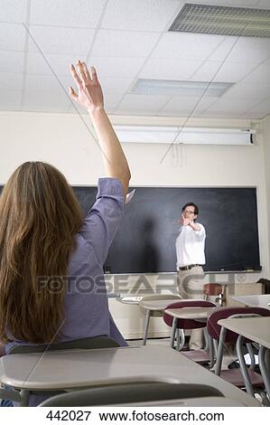 Student with hand raised in lecture room View Large Photo Image Stock Photo - Student with hand raised in lecture room. Fotosearch